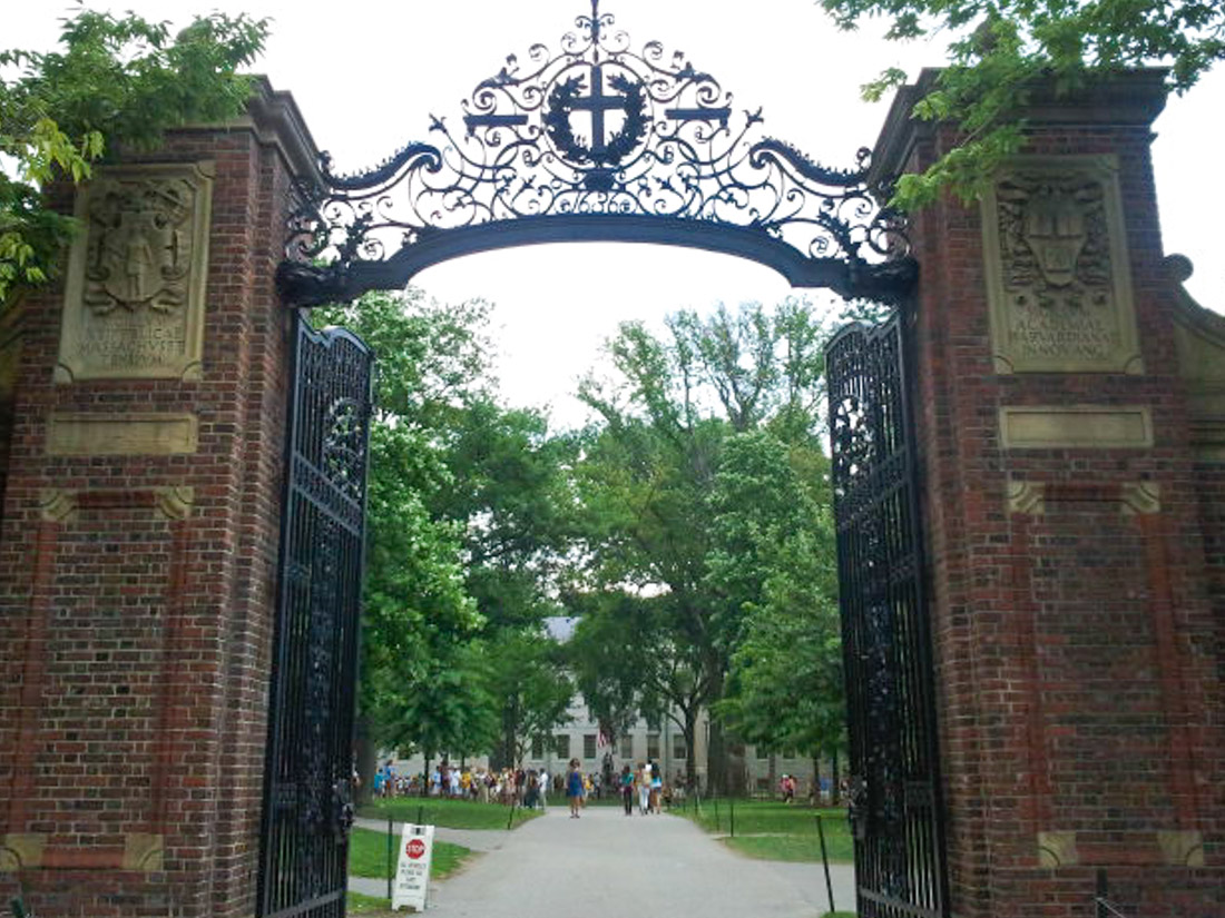 Red bricked walls and black Harvard Gates in Boston