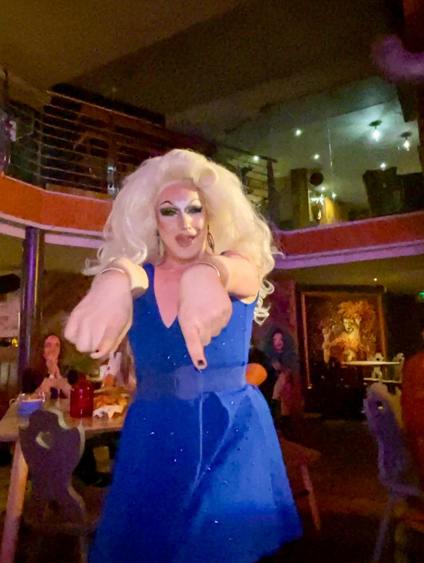 Drag queen artist dancing at bar