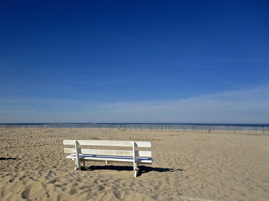 White bench on sand at Lewes, Delaware