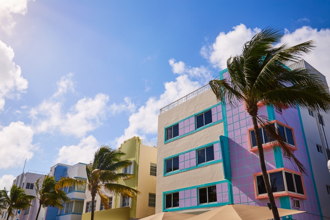 Art deco buildings and palm trees on Ocean Beach Boulevard in Miami