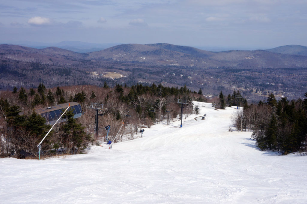New England Ski Trail and Chairlift with Mountains In the Background In a Vermont Ski Resort. 