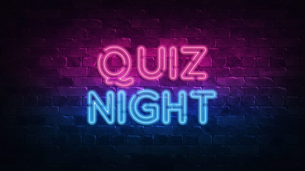 Neon quiz night sign against black background