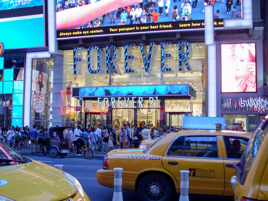 Street with taxis, crowds and Forever 21 store