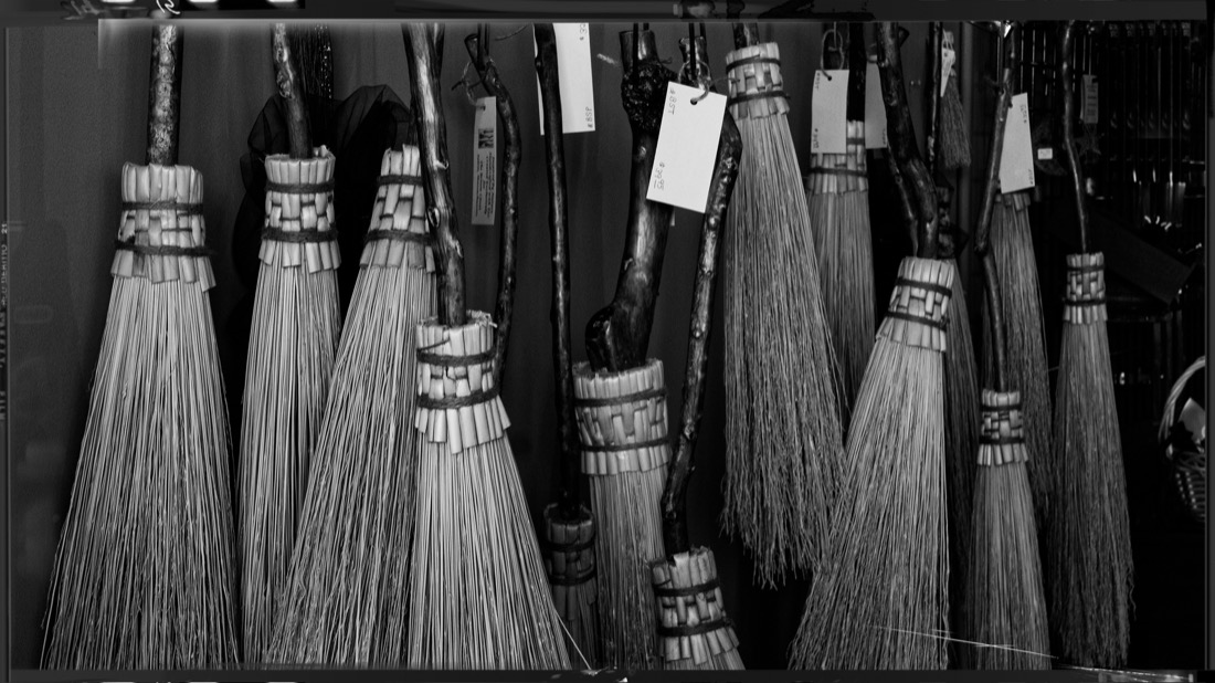 Black and white image of Witches brooms in Salem shop