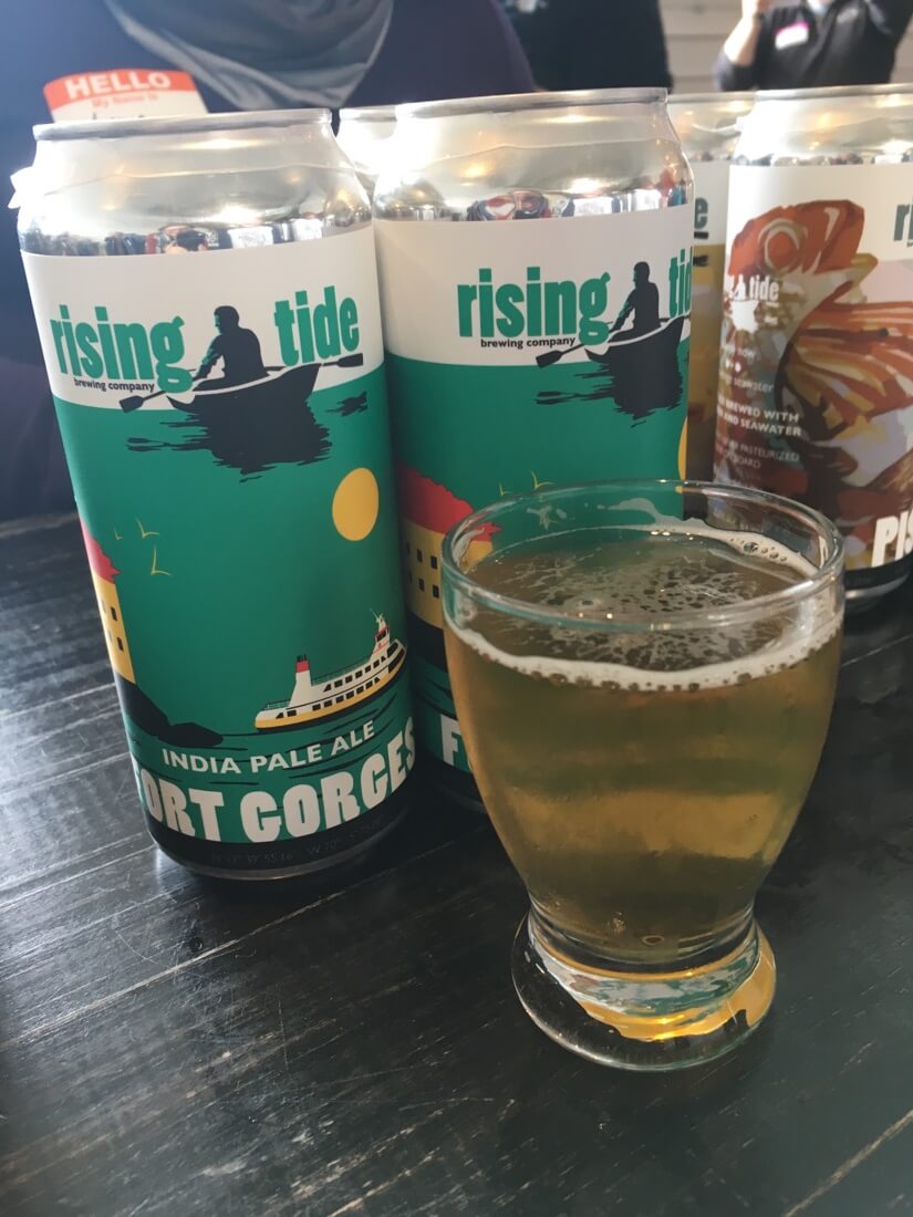 Cans of beer and a sample from Rising Tide Brewing Company