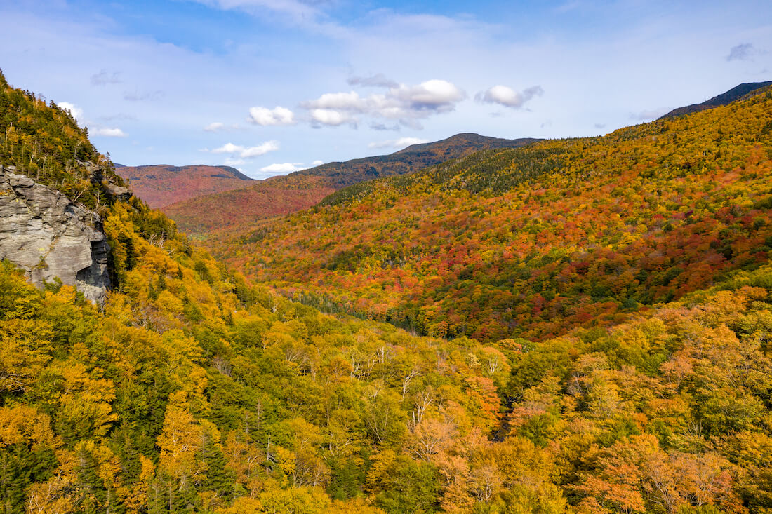 A panoramic view of peak fall foliage in Smugglers Notch, Vermont