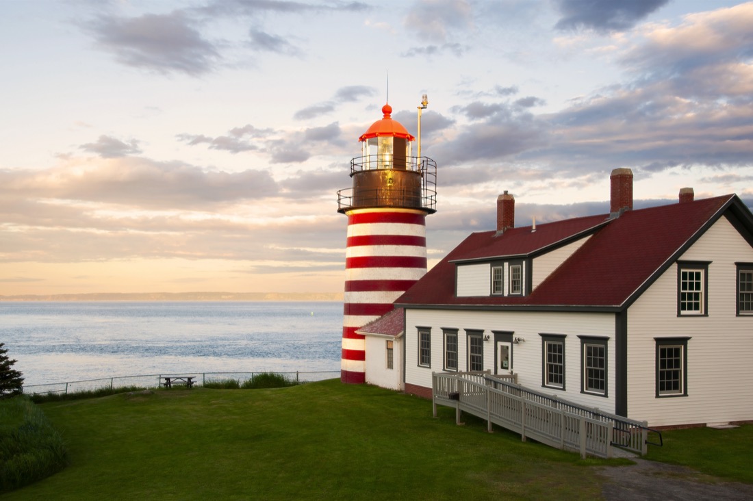 Red and white striped lighthouse West Quoddy Head Lighthouse Maine at sunset
