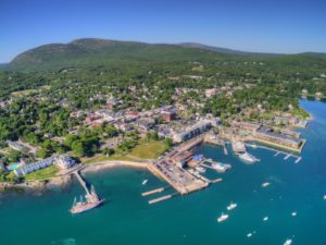Aerial view of Bar Harbor, Maine, on Mt Desert Island with Acadia National Park beyond the coastal town