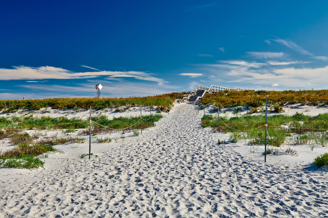 View from the shore looking back across the sand at Crane Beach in Ipswich Massachusetts with a wooden staircase 