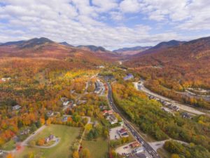 Lincoln Main Street at town center and Little Coolidge Mountain on Kancamagus Highway aerial view with fall foliage, Town of Lincoln, New Hampshire