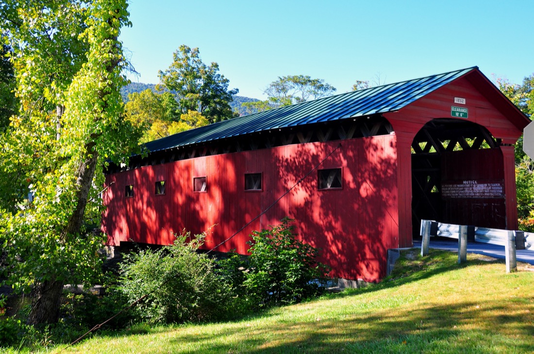 Blue skies over Arlington Covered Bridge with green grass