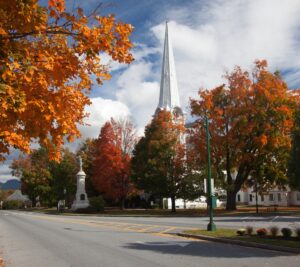 Autumnal shot of the main street of Manchester Vermont in fall as the bright trees turn orange and red