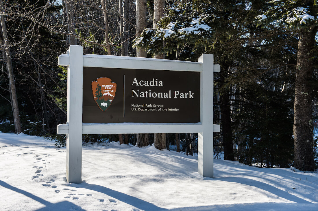 Entrance sign to Acadia National Park in Maine in winter