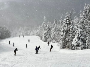 Skiiers on a snowy day at Okemo Mountain Resort in Ludlow Vermont