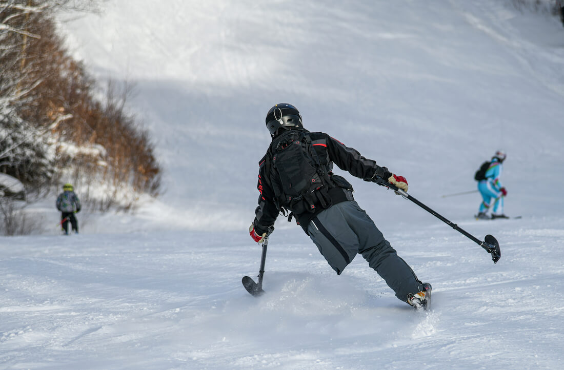 An adaptive skier going downhill at Stowe Mountain Resort 