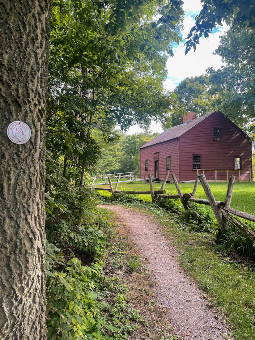 Red wooden building and trail and Ethan Allen Homestead Museum and Historic Site Burlington Vermont path