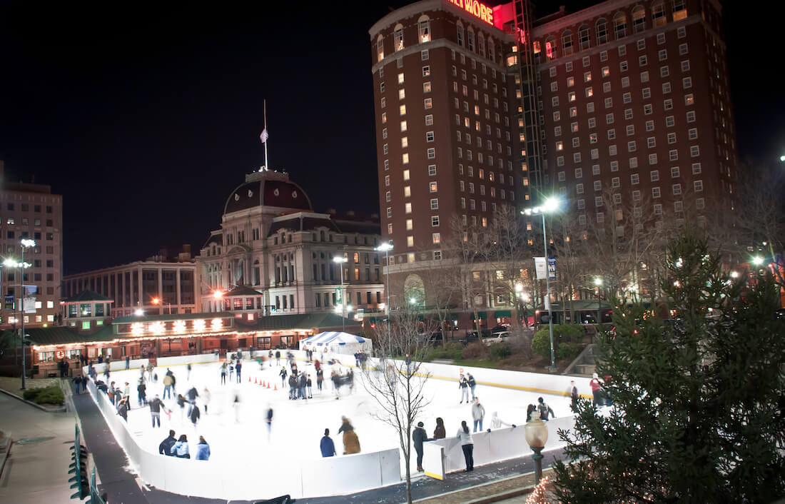 People ice skating on an outdoor skating rink in downtown Providence Rhode Island