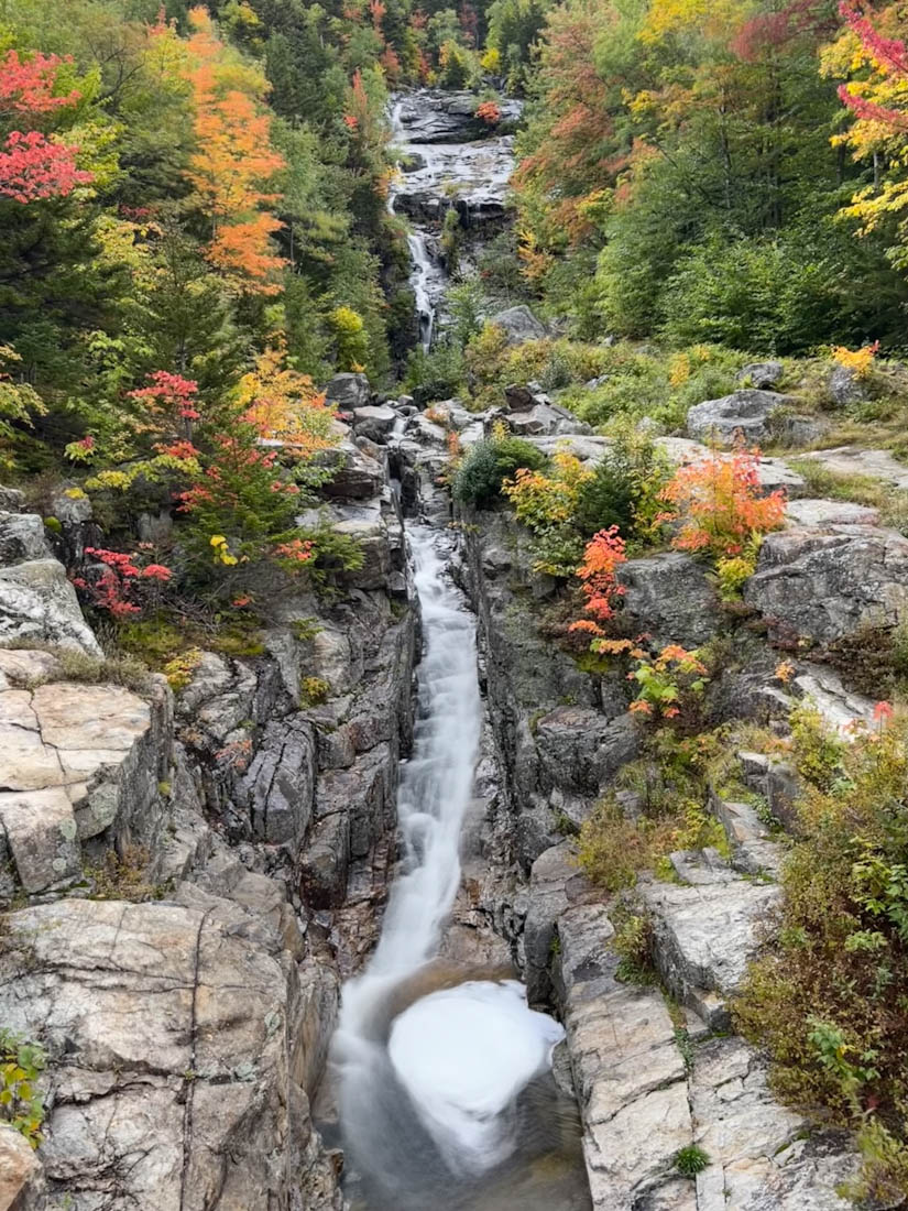 Silver Cascade waterfall flow by side of road New Hampshire in fall