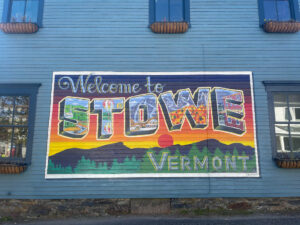 Welcome to Stowe Vermont postcard mural on a blue building