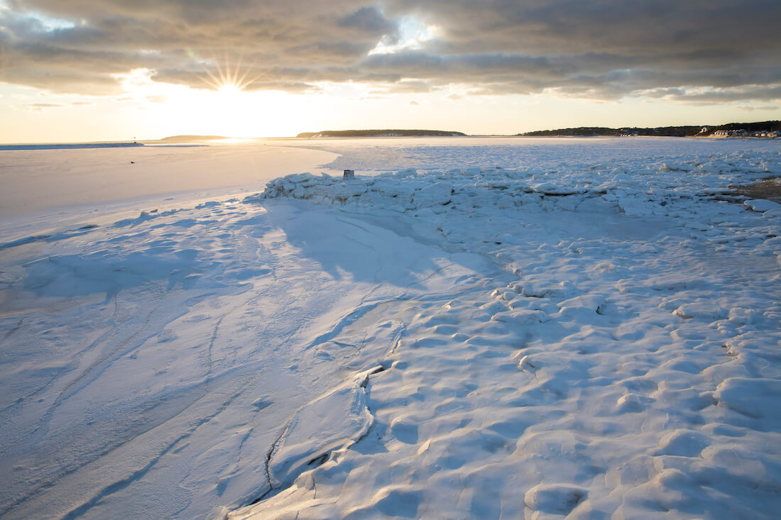 A scenic view of Wellfleet Bay frozen over in the winter time Cape Cod Massachusetts