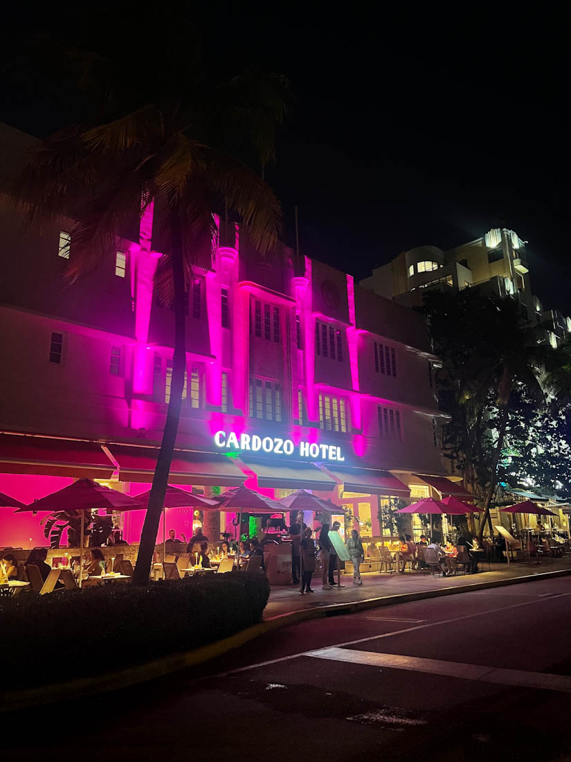 Cardozo Hotel lit up in pink at night on Ocean Drive South Beach in Miami Florida