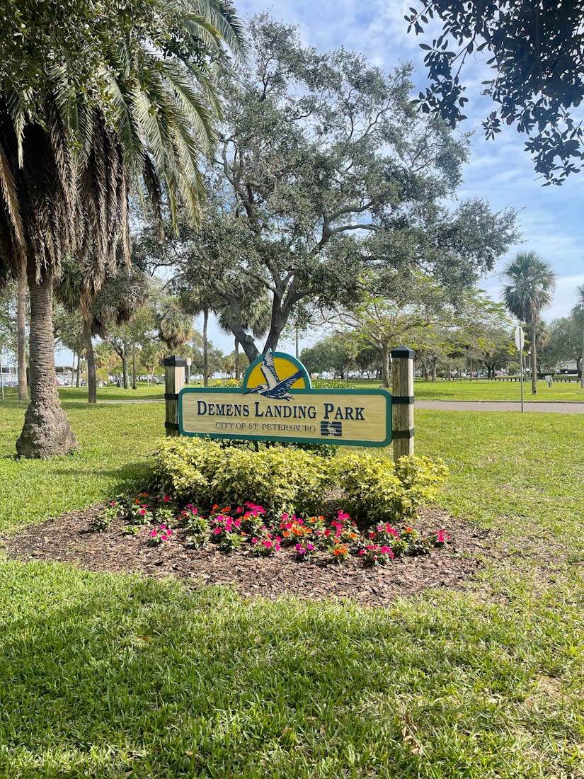 Demens Landing Park sign surrounded by trees and greenery in St Pete Florida
