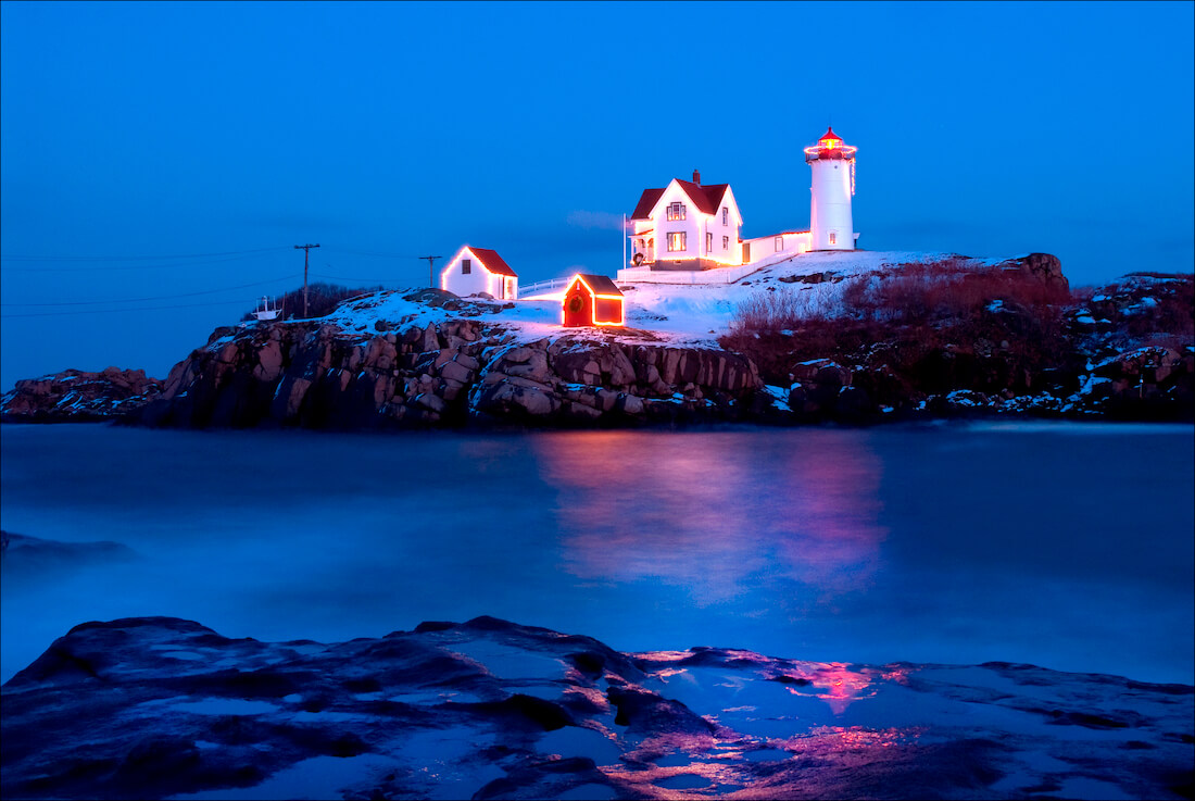 Nubble Lighthouse in Maine lit up with festive lights for the holiday season