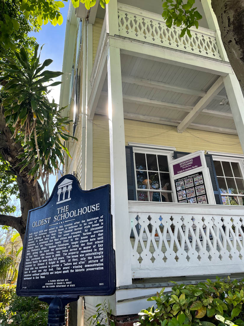 Two storey, house with white porch and sign saying Oldest Schoolhouse in Key West