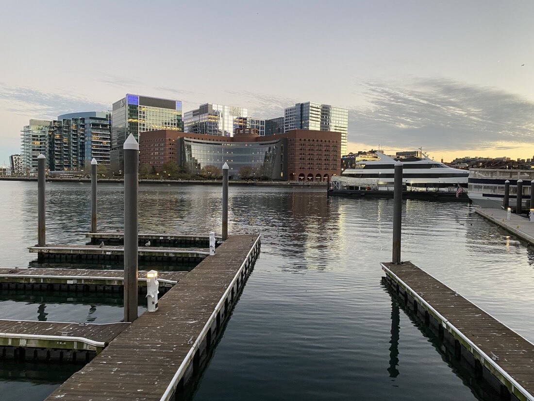 View from The Harborwalk toward The Seaport in Boston Massachusetts at dusk