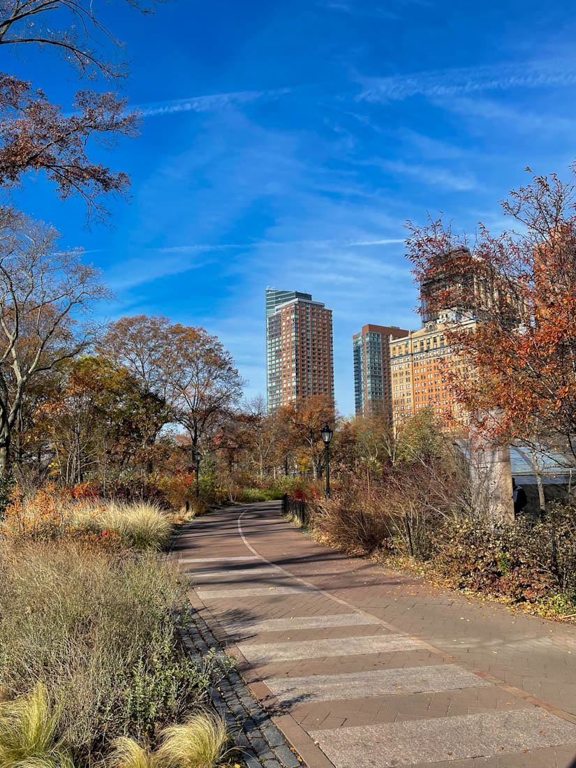 Battery Park pathway with fall colors in NYC New York