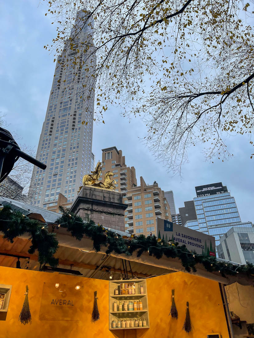 Columbus Circle Holiday Market with skyscraper in background in NYC New York