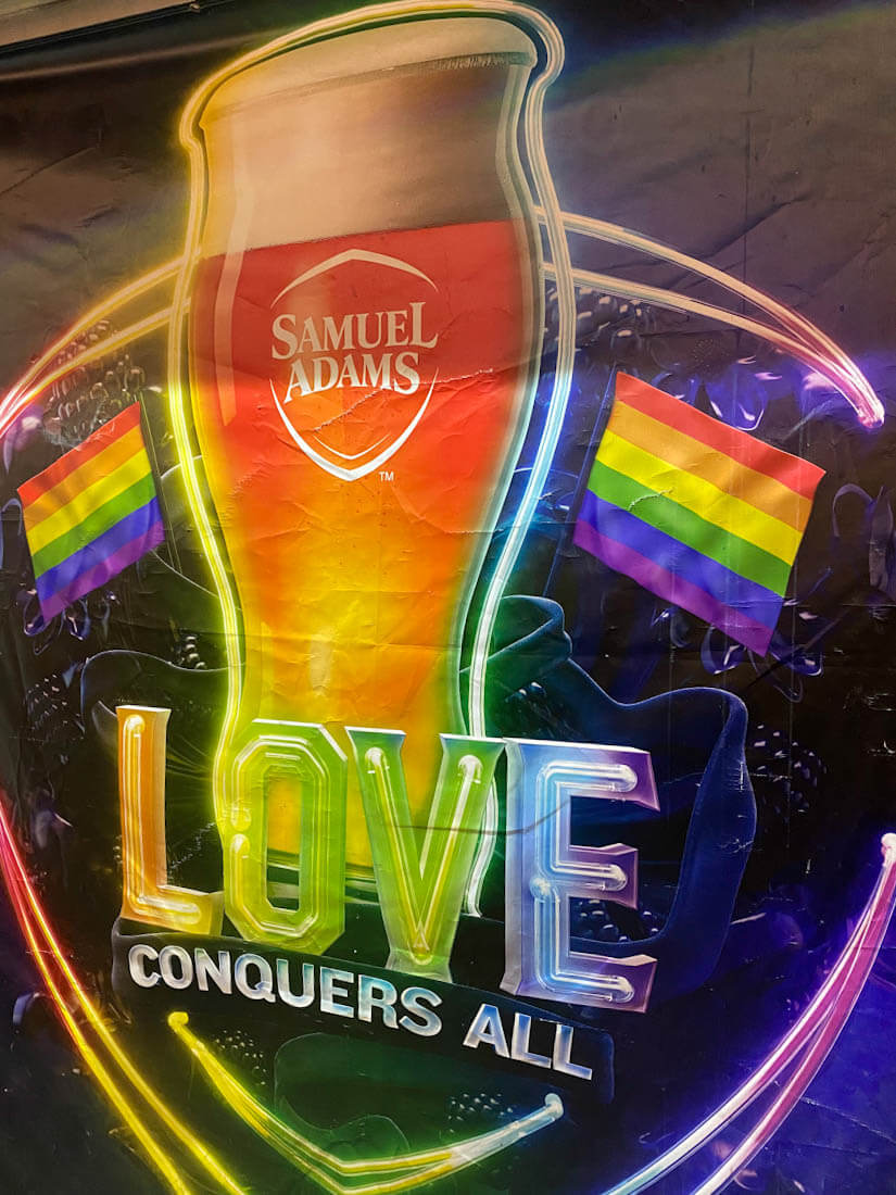 Love Conquers All sign at the Sam Adams Brewery Taproom in Jamaica Plain Boston Massachusetts