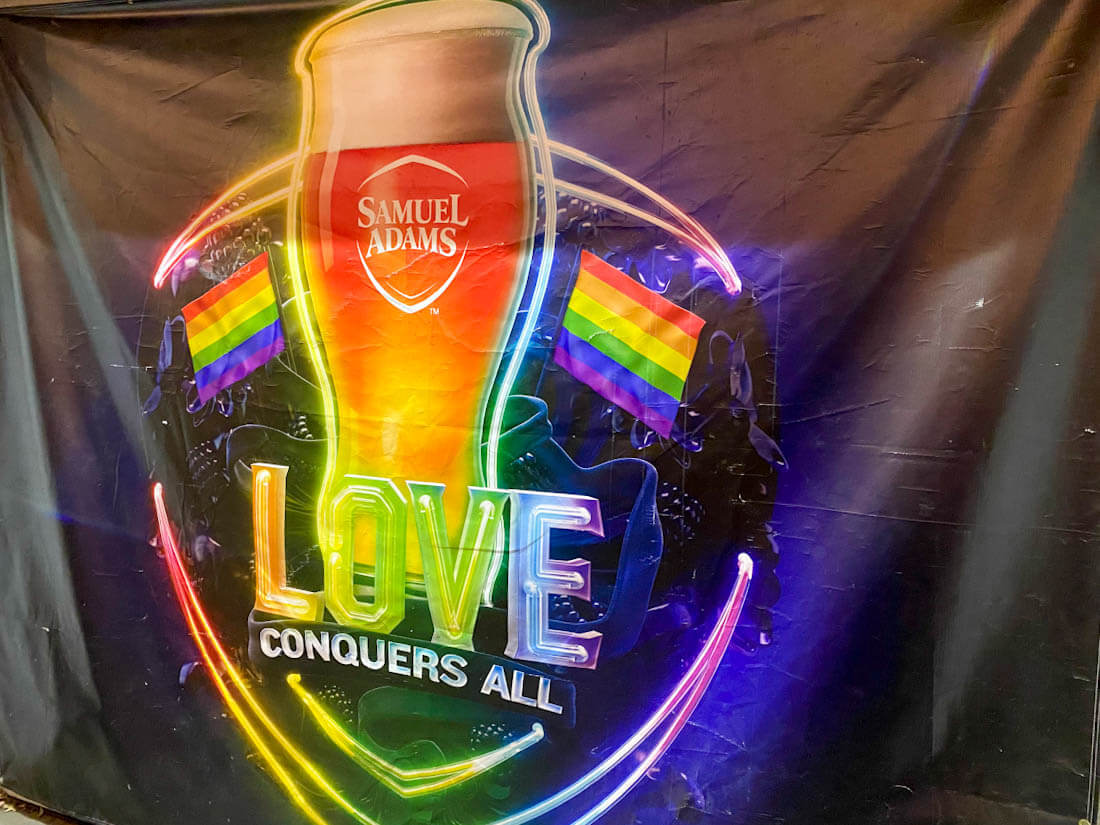 Love Conquers all rainbow banner at the Sam Adams Brewery Taproom in Jamaica Plain Boston Massachusetts