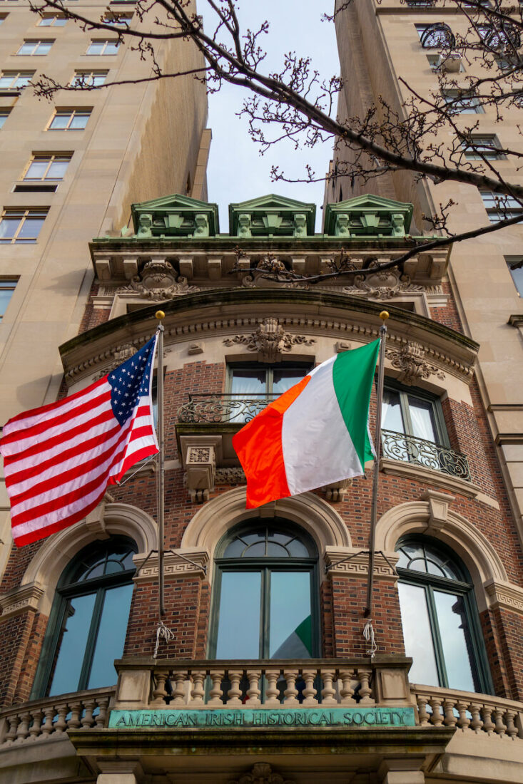 The American Irish Historical Society building in NYC with US and Irish flags hanging out front