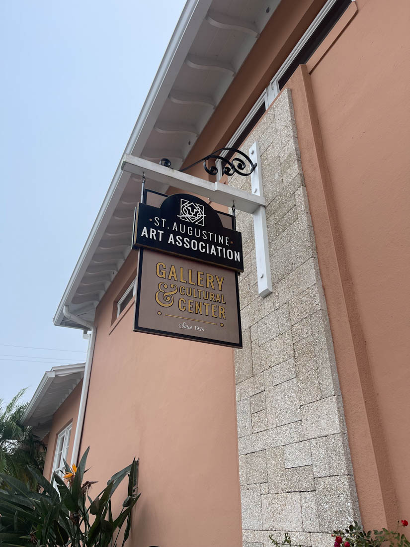 St Augustine Art Association sign against pink wall in Florida