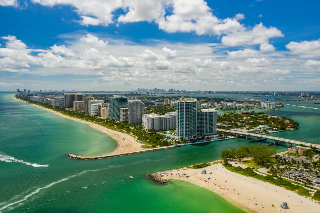 Aerial photo Miami Beach inlet between Haulover and Bal Harbour with high rise hotels, sand and ocean