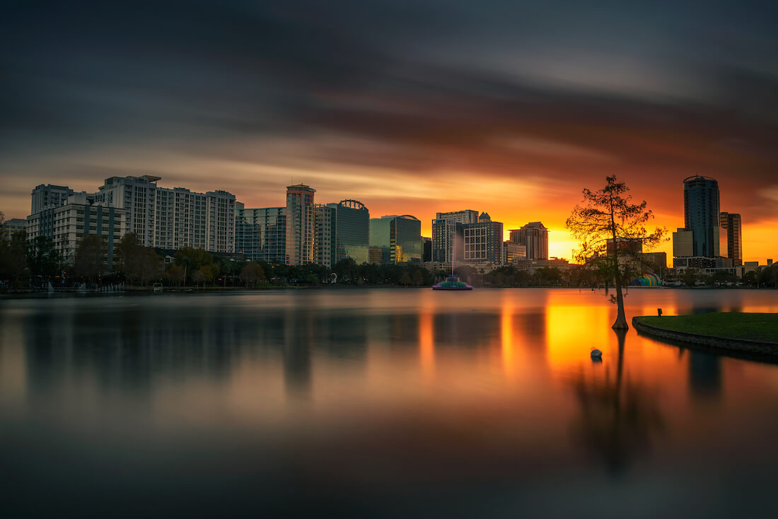 Sunset behind the skyline and Lake Eola in Orlando Florida