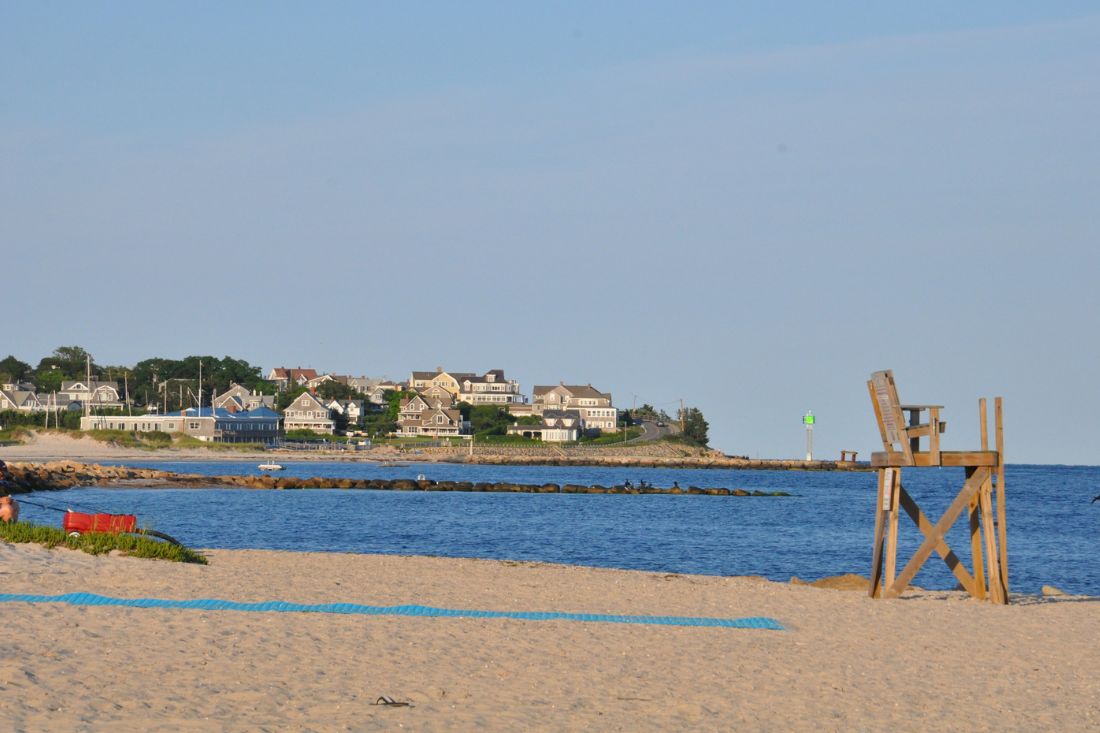 View of beach in Falmouth, MA with houses on the background.