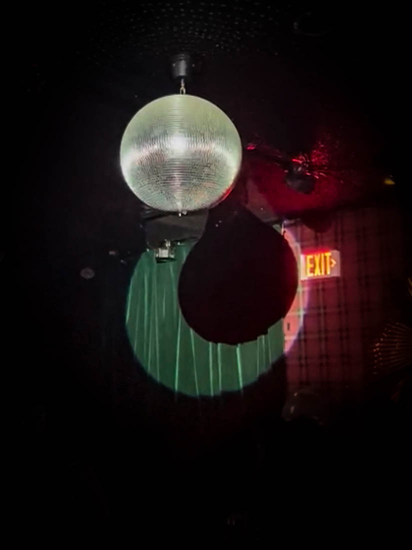Disco ball against red walls of The Anderson club in Miami 