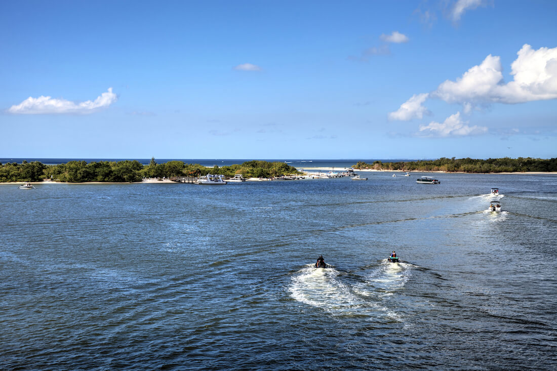 Boats and jet skis approaching the pass between Fort Myers Beach and Lovers Key State Park