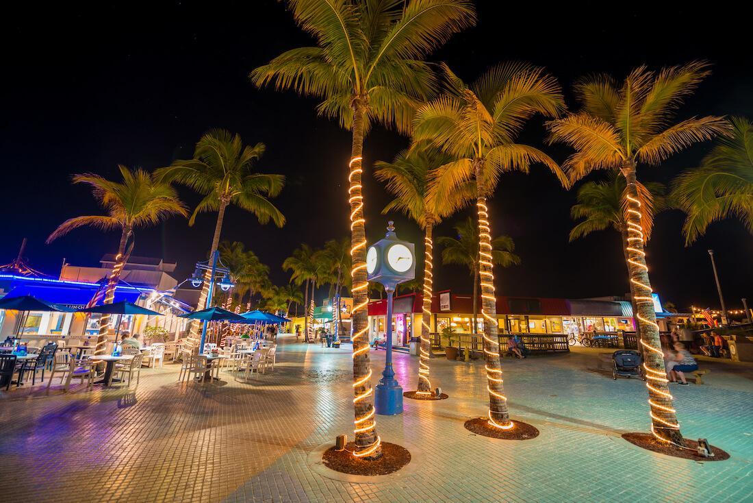 Fort Myers Beach Times Square at night with lights around palm trees