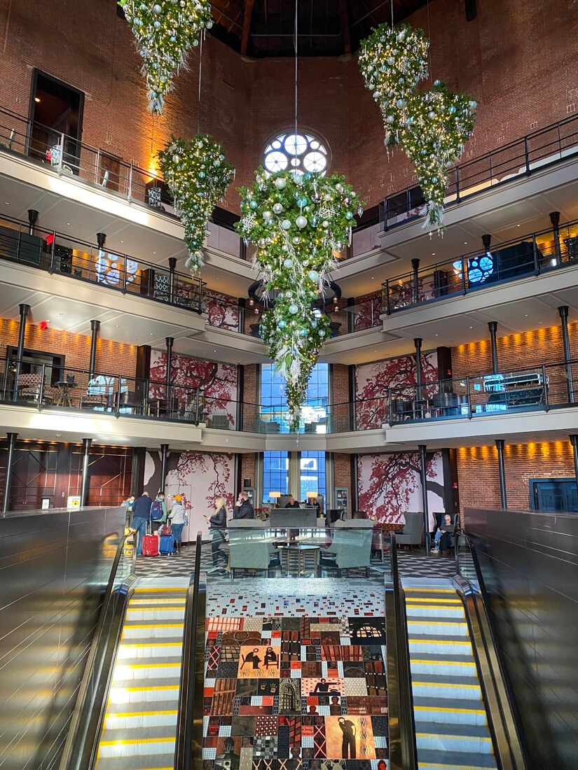 Hanging Christmas trees inside The Liberty Hotel lobby Boston Massachusetts