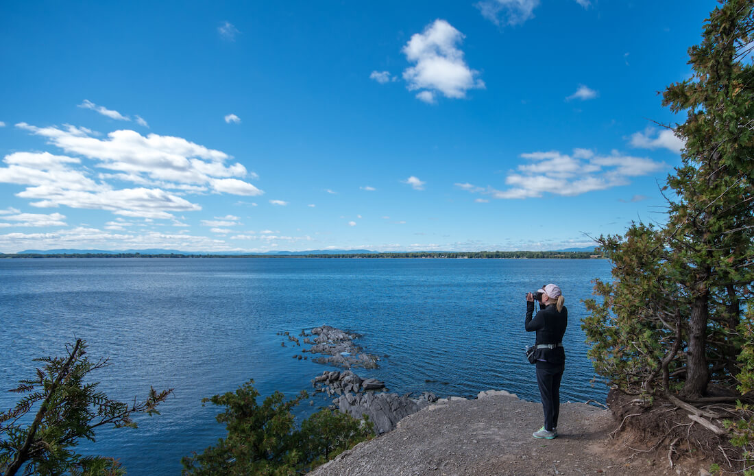 Person on a rocky overlook at Point Au Roche State Park in New York