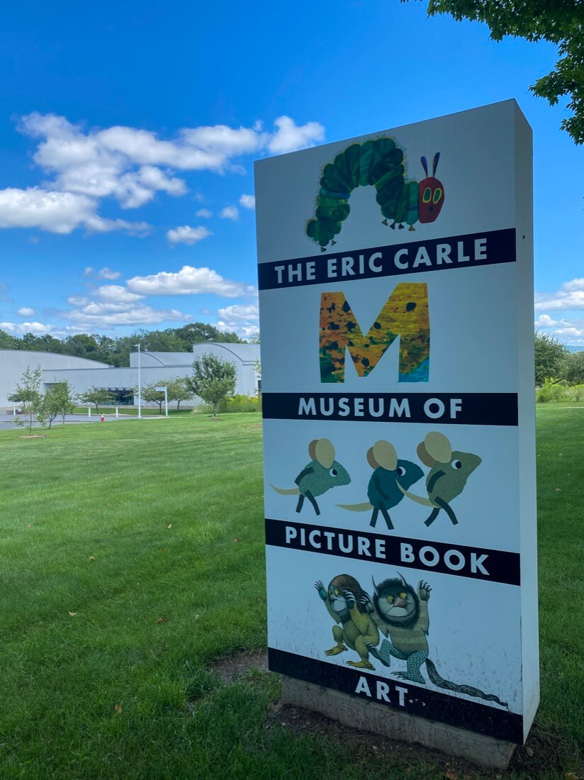 The Eric Carle Museum of Picture Book Art sign and building in the background in Amherst Massachusetts