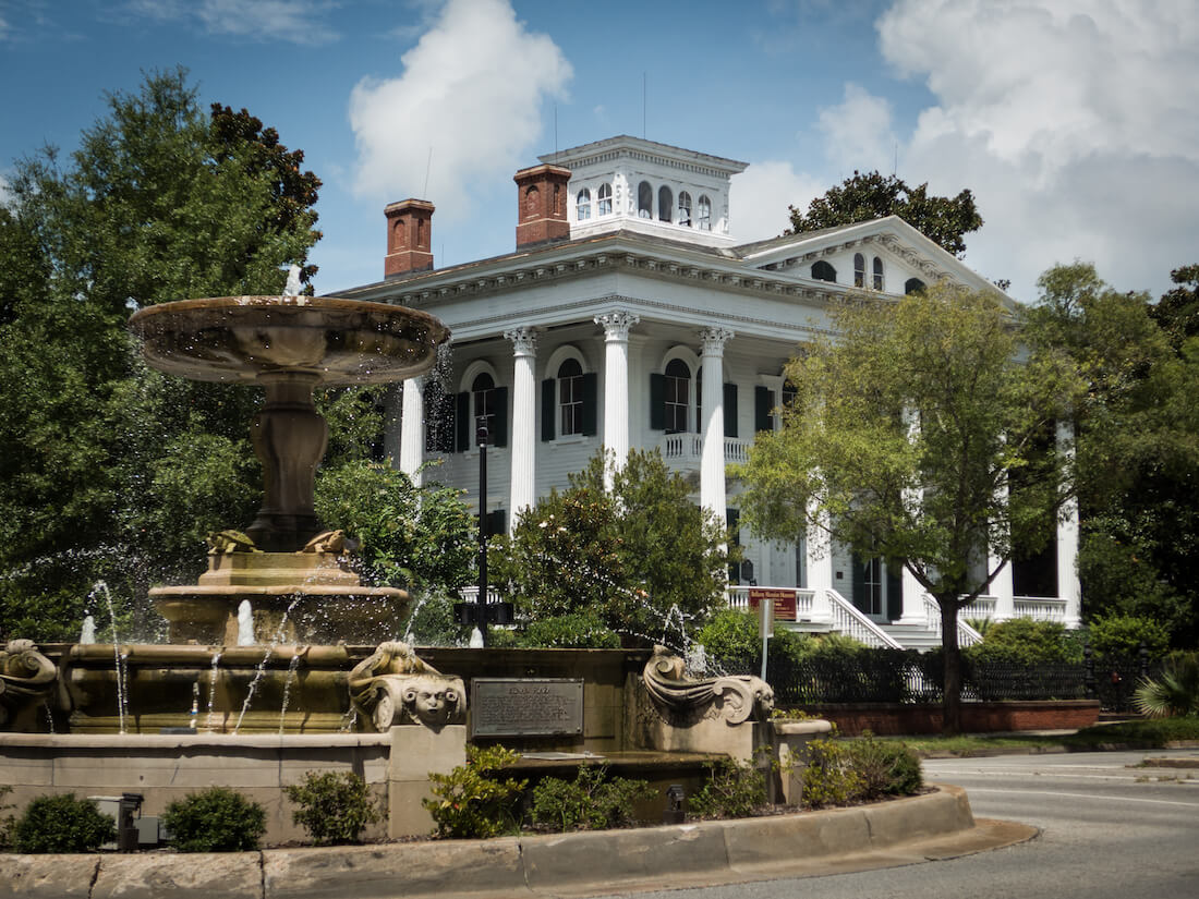 Beautiful fountain and historic Bellamy Mansion on sunny day in Wilmington NC