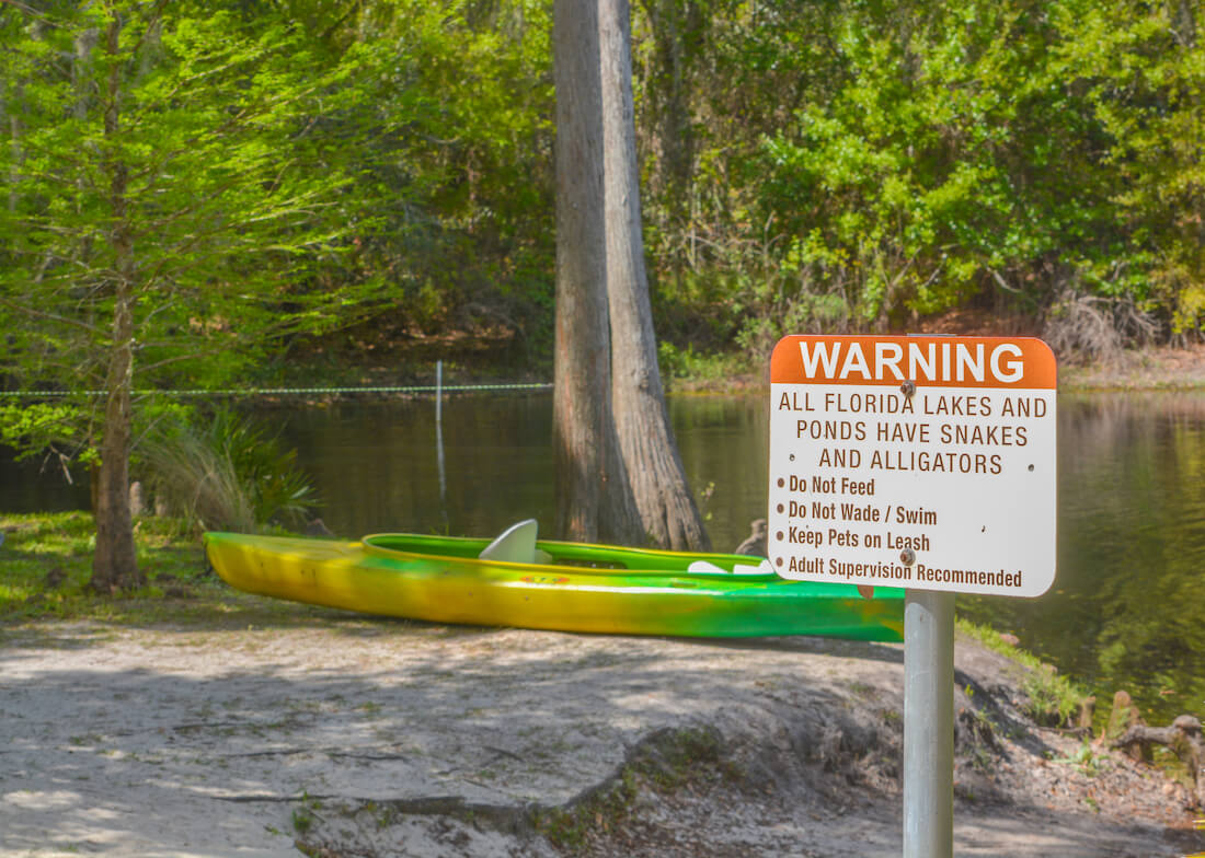 A warning sign about kayaking on the Shingle Creek at Shingle Creek Regional Park, Osceola County, Kissimmee, Florida