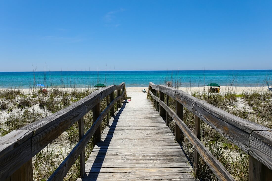 A beautiful view of a wooden path going to Henderson Beach State Park Destin Florida