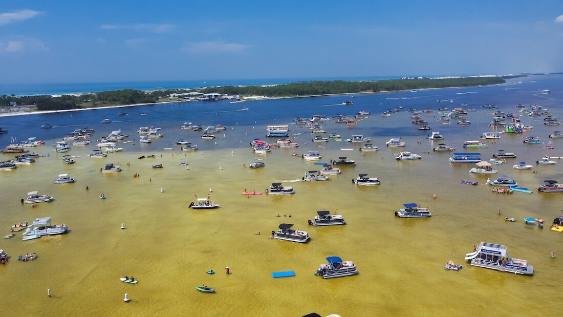 Aerial view of busy Crab Island near Okaloosa Island Grass Flats in Destin Florida