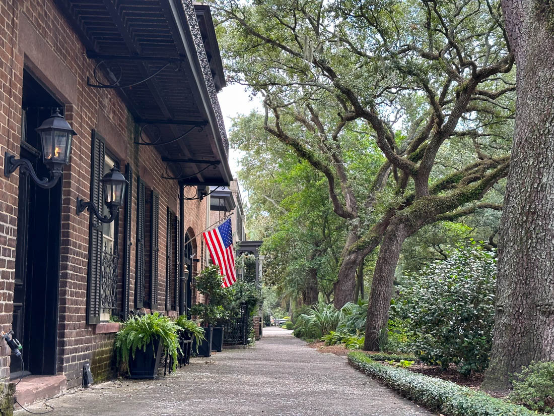 East Jones Street Mansions with US Flags and Oak Trees in Savannah Georgia