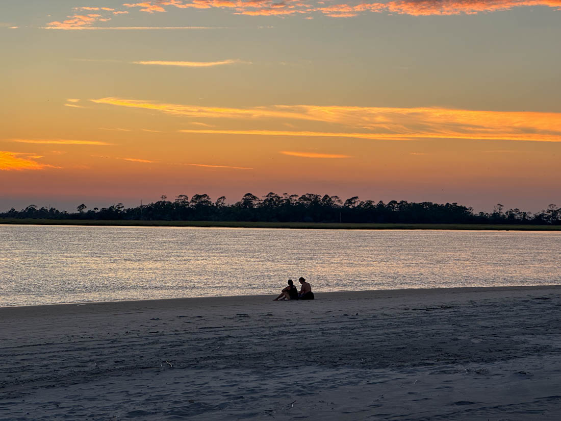 Intent Sunset at Tybee Creek with Shadow of Couple 